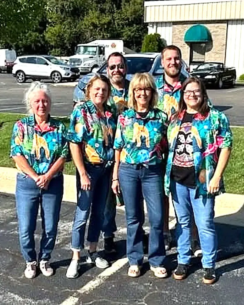 Emerald Property Management team group photo in matching shirts outside the office