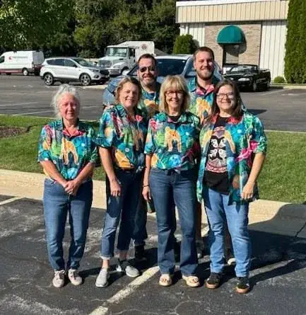 Emerald team group photo in matching shirts outside the office